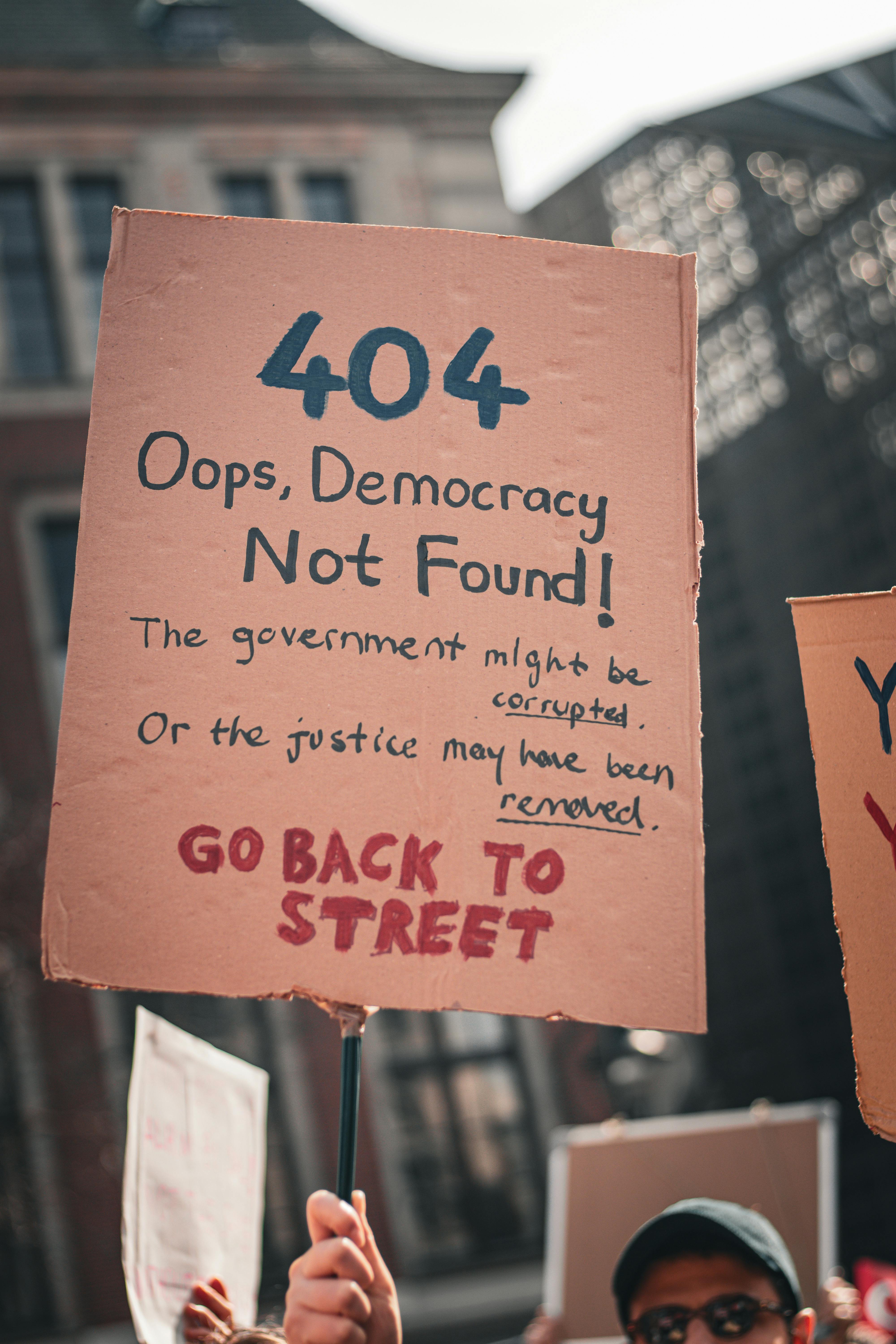 Young people at a street demonstration holding a protest placard